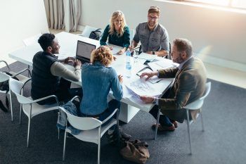 Group of people sat around a desk